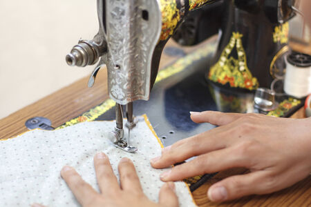 Retro style manual sewing machine workingの写真素材