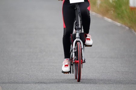 Girl travel by bicycle on the road.