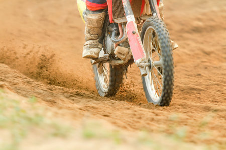 Motocross racer accelerating speed in trackの写真素材