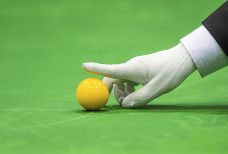 Snooker referee set up ball for new gameの写真素材