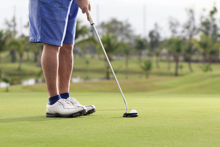 Golf player putting on the greenの写真素材