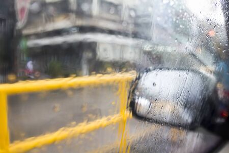 Drops on the window side door in rainの写真素材