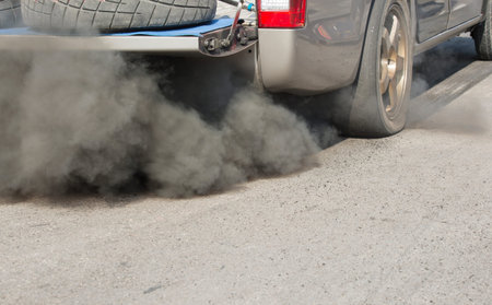 Air pollution from vehicle exhaust pipe on roadの写真素材