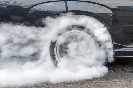 Drag racing car burns rubber off its tires in preparation for the raceの写真素材