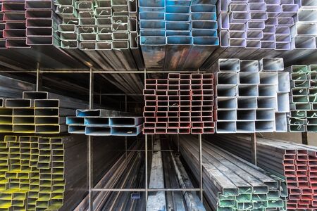 Steel pipe and steel beam and construction material on shelf in warehouseの写真素材