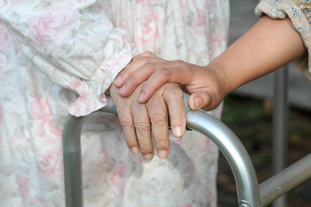 senior woman use a walker at home with caregiver