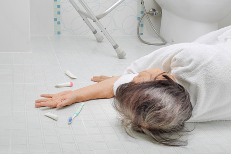 Elderly woman falling in bathroom because slippery surfacesの写真素材