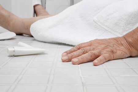 Elderly woman falling in bathroom because slippery surfacesの写真素材