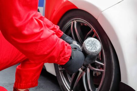 Auto mechanic changing car wheelの写真素材