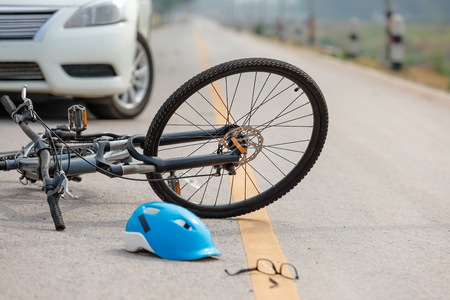 Accident car crash with bicycle on roadの写真素材
