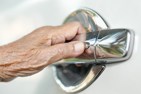 elderly woman hand opening car doorの写真素材