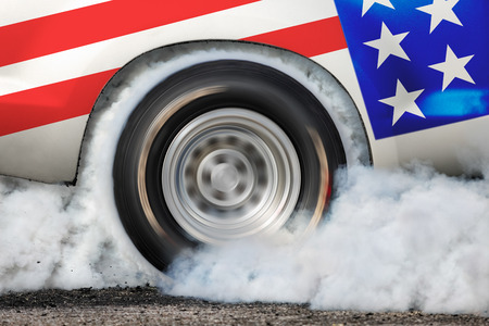 Drag racing car burns rubber off its tires in preparation for the raceの写真素材