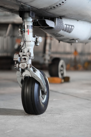 Front landing gear of aircraft on the groundの写真素材