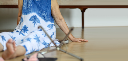 Elderly woman falling down at home, hearth attack.の写真素材