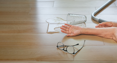 Elderly woman falling down at home ,hearth attack.の写真素材