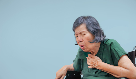 elderly woman cough ,choke on wheelchairの写真素材
