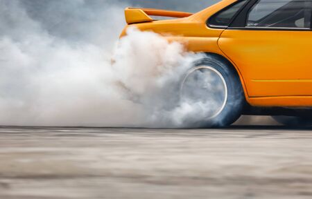 Race drift car burning tires on speed trackの写真素材
