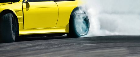 Race drift car burning tires on speed trackの写真素材