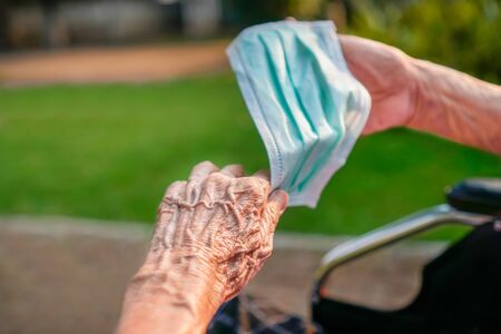 Elderly woman wearing a mask to protect from coronavirus covid-19の写真素材