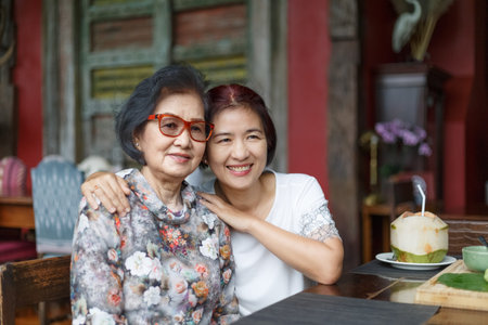 Senior asian woman with daughter relaxing on vacation together in mothers day.の写真素材