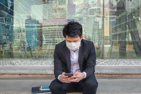 Business man in distress of job losses due to COVID-19 virus pandemicの写真素材