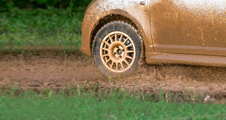Rally racing car on muddy track.の写真素材