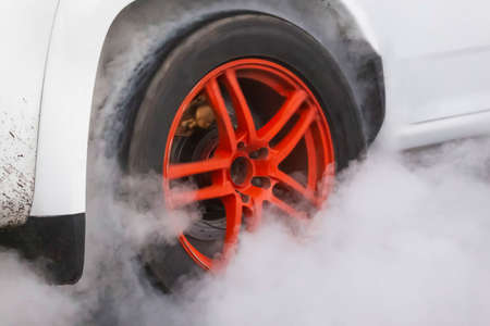 Drag racing car burns rubber off its tires in preparation for the raceの写真素材