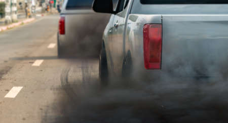 air pollution crisis in city from diesel vehicle exhaust pipe on roadの写真素材