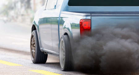 air pollution crisis in city from diesel vehicle exhaust pipe on roadの写真素材