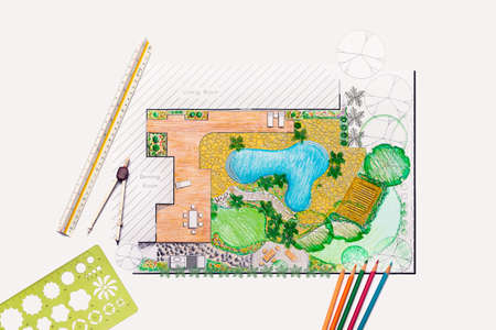 Landscape architect student designing backyard garden and pool plan for villa.の写真素材