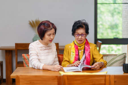 Asian middle aged daugther takecare senior mother at homeの写真素材