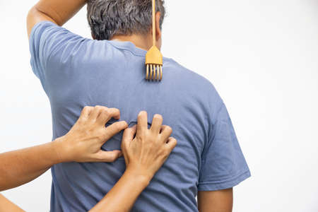 Senior man and his wife scratching his backの写真素材