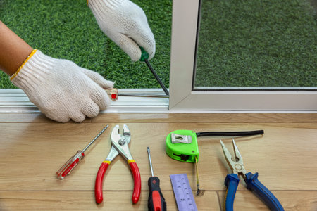 Worker fixing the insect screen sliding doorの写真素材