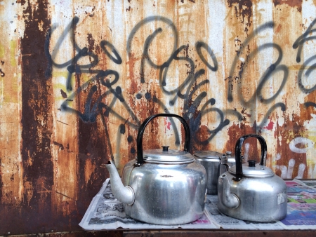 Teapots against graffiti wallの素材