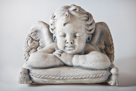 Angel on upholstery with light background  の写真素材