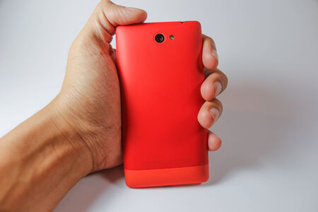 holding orage smart phone back sideの写真素材