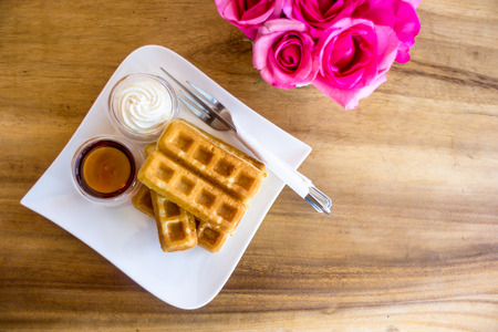 Waffle with maple syrup and fresh milk creamの写真素材