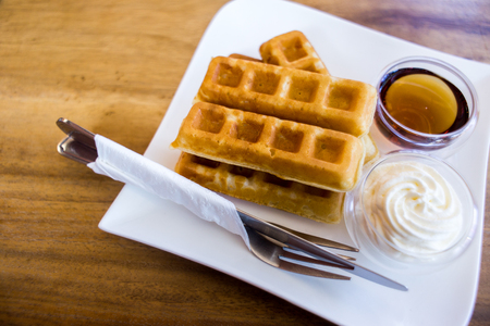 Waffle with maple syrup and fresh milk creamの写真素材