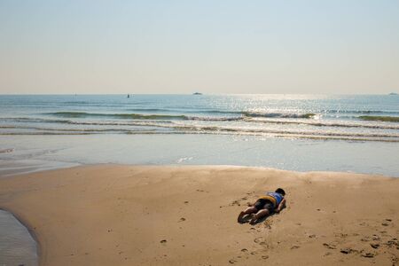 one man planking on the beachの写真素材