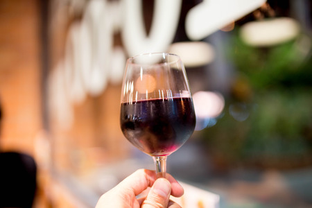holding a glass of wineの写真素材