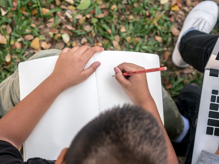 child drawing on a white notepad