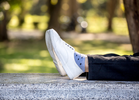 white girl sneaker in nature sitting relaxの写真素材