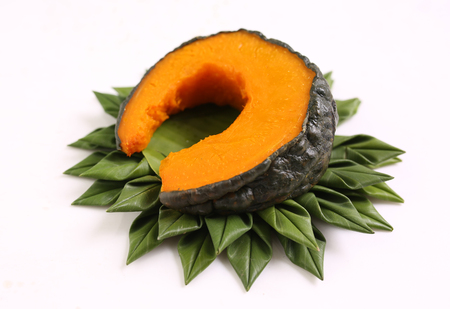 Boiled pumpkin on green banana leaf basket.の写真素材