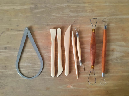 Sculpture and pottery tool on wood table for art studio concept.