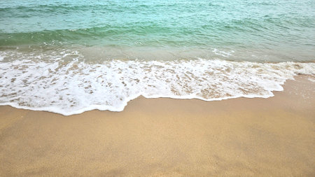Sea water wave and sand beach with seashell background for decoration on summer holiday and coastal concept.の写真素材