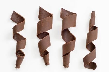 Four chocolate spirals on white background - overheadの写真素材