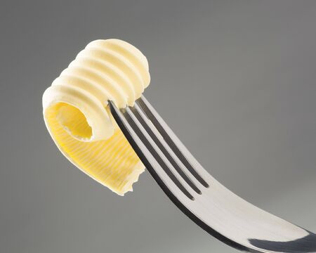 Closeup of a butter curl on a forkの写真素材