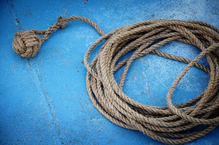Rope  coiled on a blue deckの写真素材