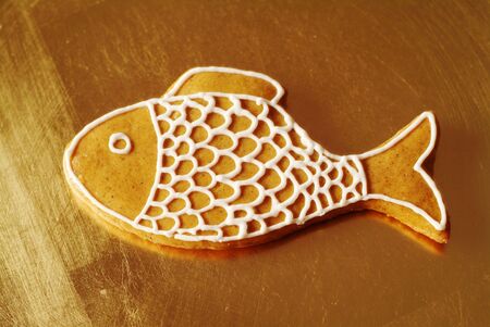 Gingerbread fish on a golden plateの写真素材