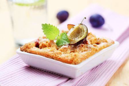 Freshly baked plum cake in a square dishの写真素材